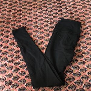 Black athleta leggings ( small hole in knee)